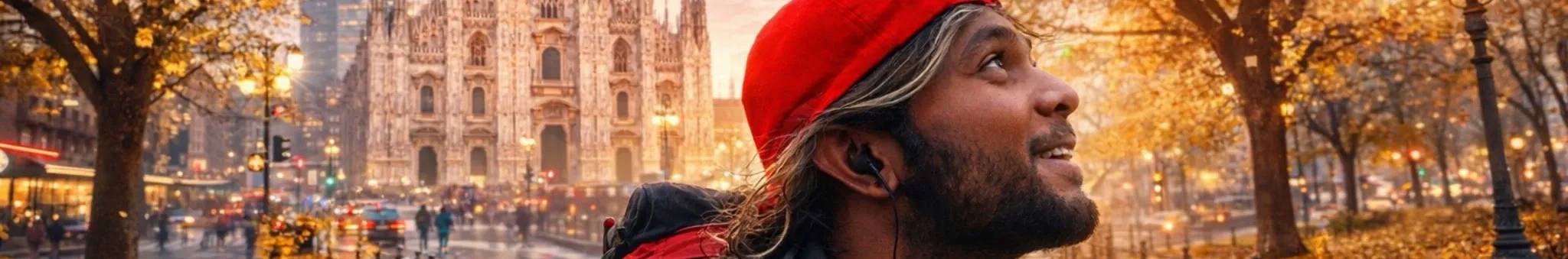 Ray in a red beanie looking up, with Milan cathedral and golden autumn trees behind him