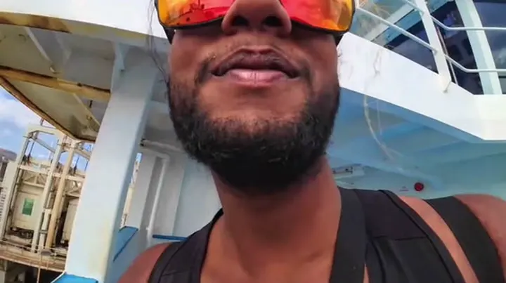 Ray smiling close to the camera on a ferry deck