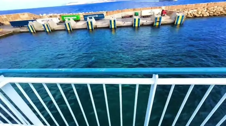 Turquoise water seen over a ferry railing